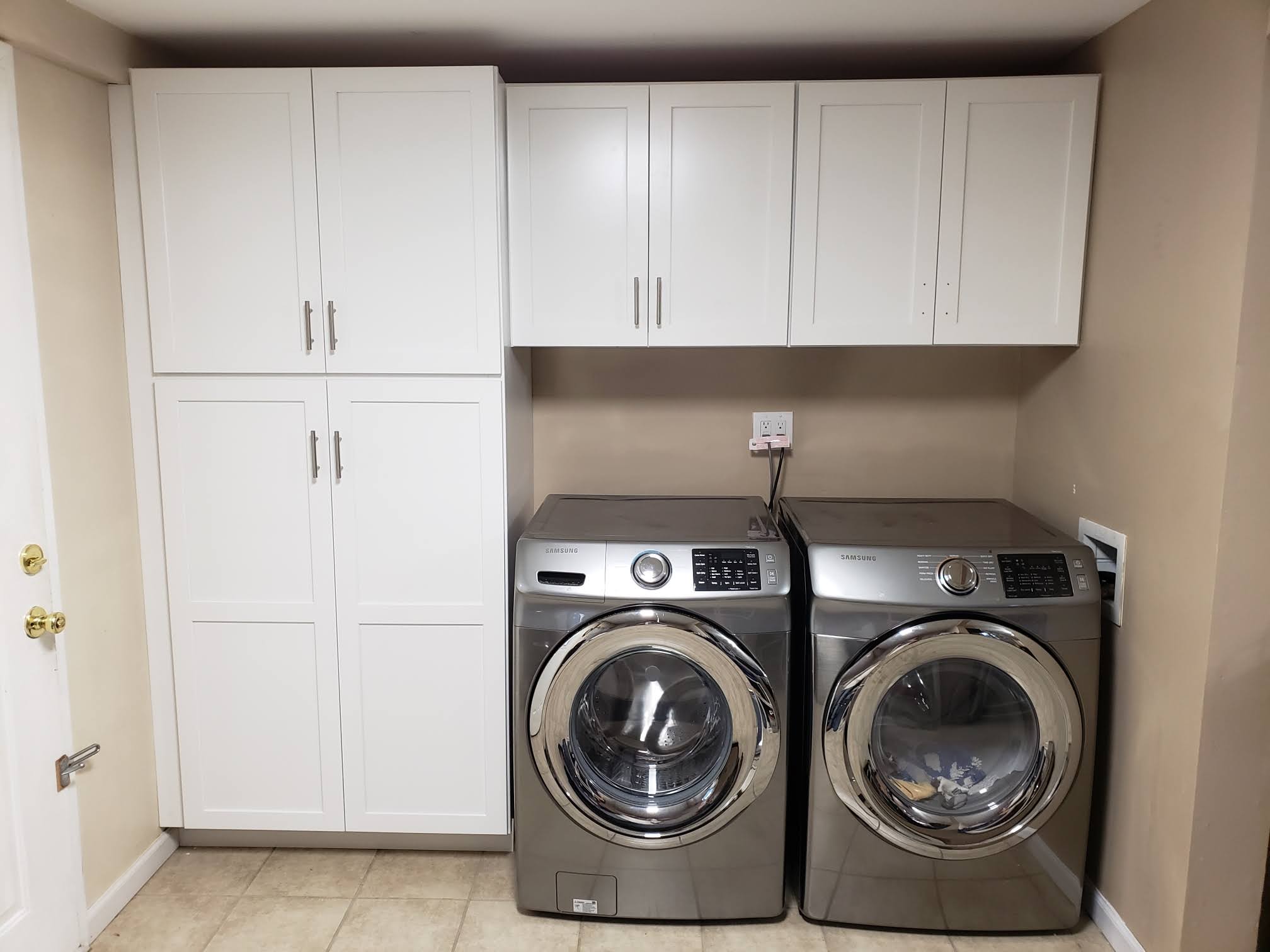 Laundry room with white cabinets